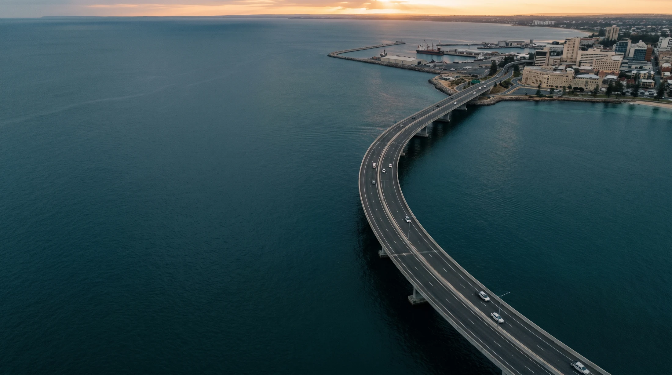 Aerial view of a coastal bridge and working port